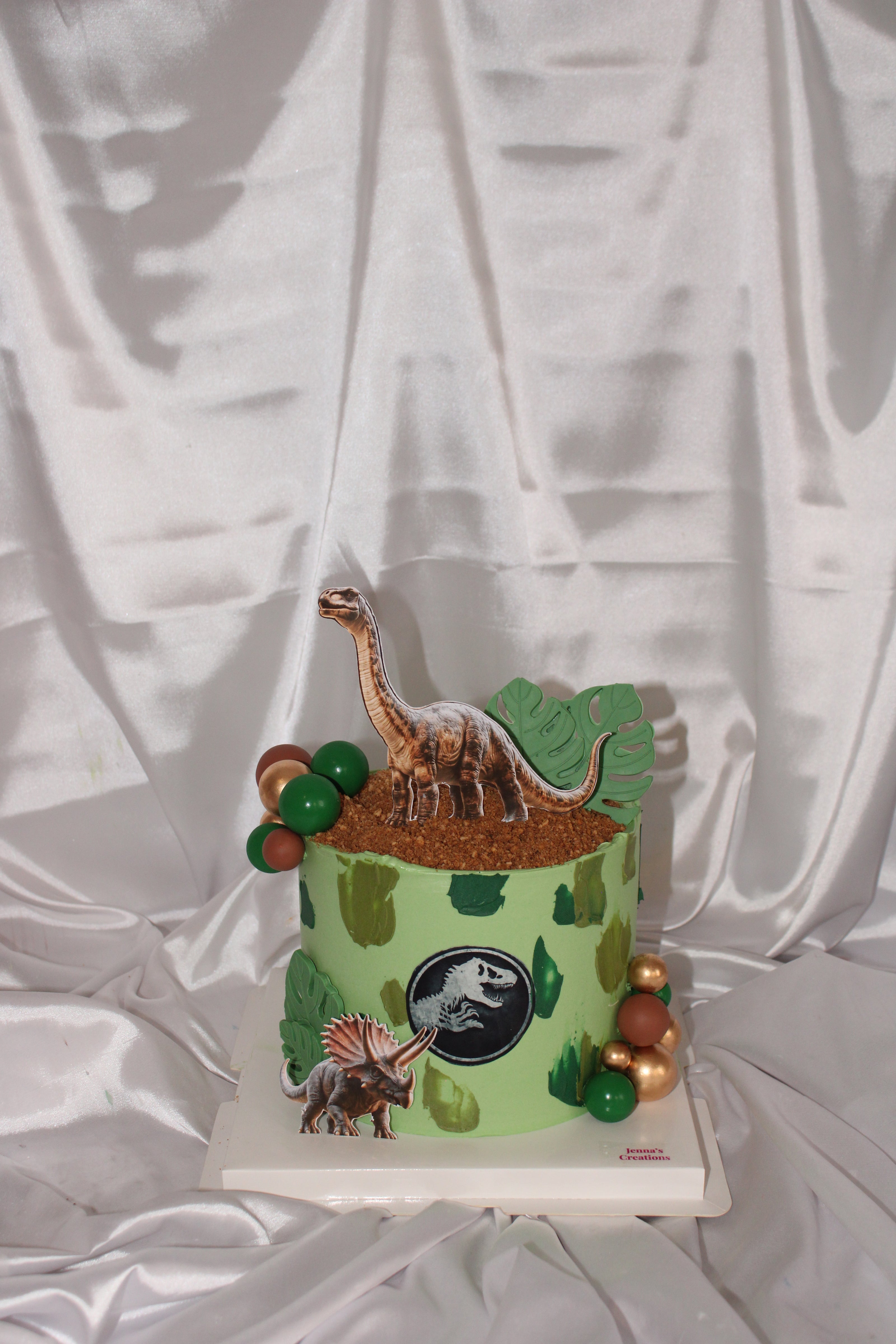 Decorative item with dinosaur design on a white fabric background