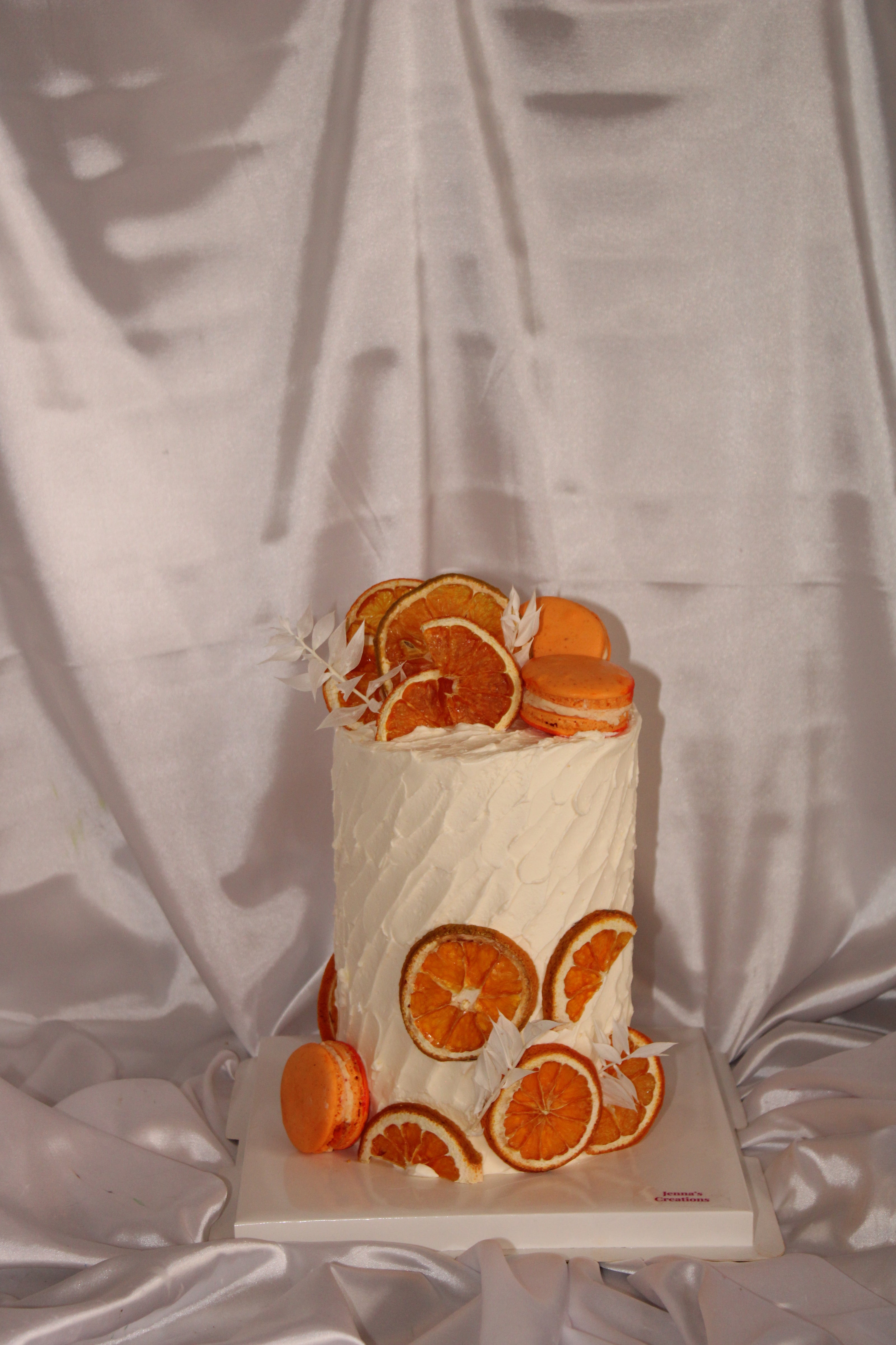 Book with orange slices arranged on it, placed on a textured surface