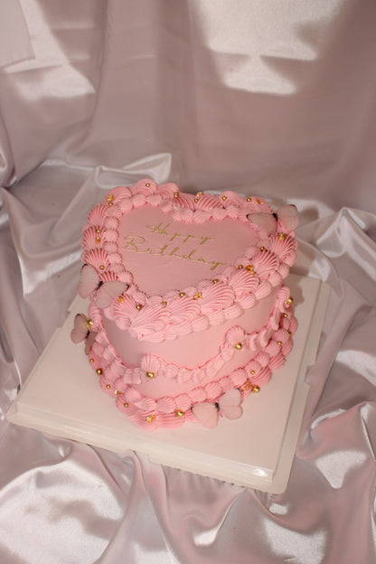 Pink hoop earrings with gold accents on a pink satin background