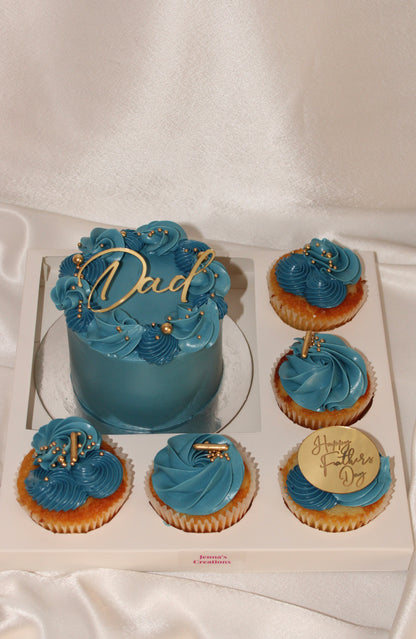 Father’s Day gift box with a blue buttercream mini cake and six matching cupcakes decorated with gold accents.
