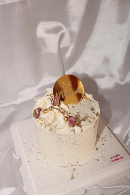 Elegant ivory Eid cake with gold splatter and sugar pearls