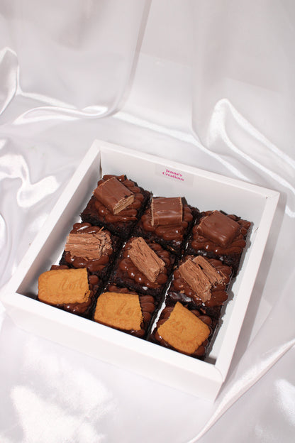 Selection of indulgent brownies featuring assorted toppings like milk chocolate pieces and biscuit layers