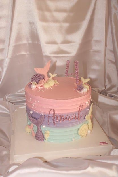 Mermaid themed birthday cake with edible shells, pearls and pastel buttercream finish