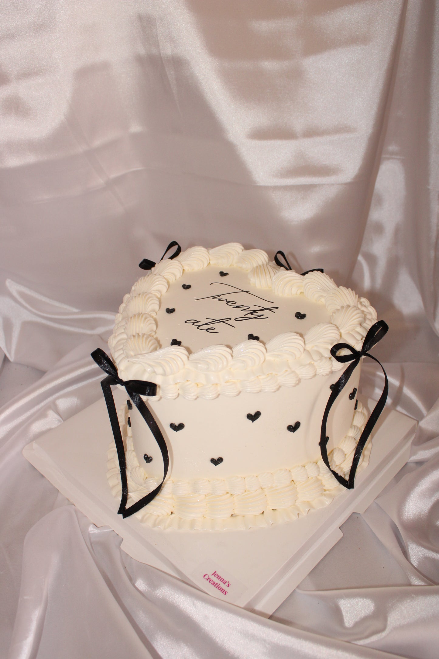 White cake with black decorations on a white background