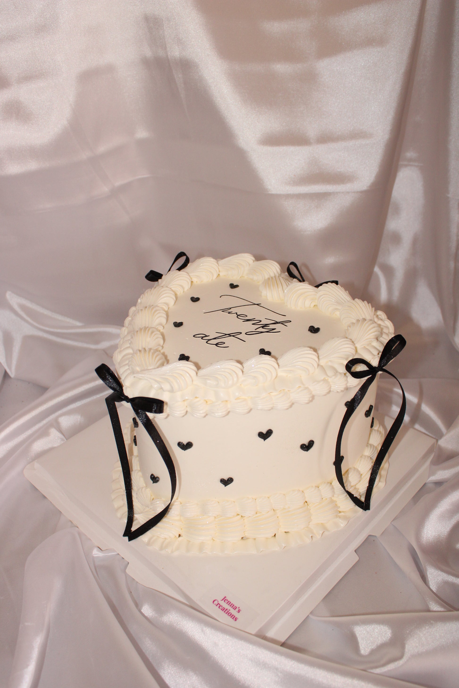 White cake with black decorations on a white background